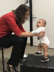 Infant stepping on treadmill with support