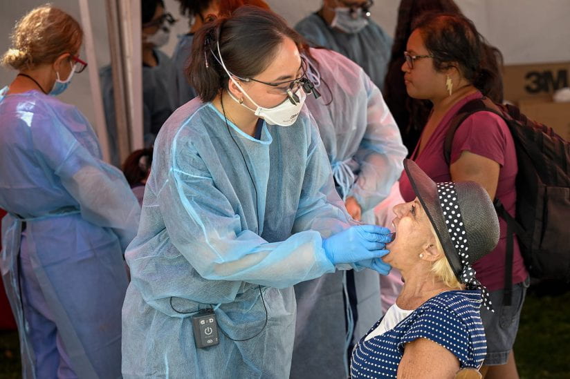 The festival offers more than just books. Here, dental student Steffi Chen performs a dental exam on author and USC alum Judi Hollis. (USC Photo/Gus Ruelas)