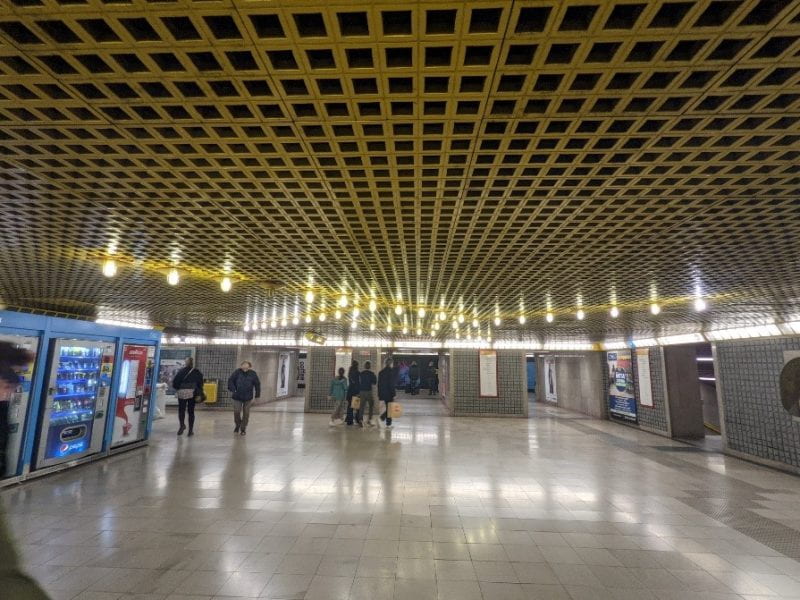 Grid patterns along the walls and ceiling inside the metro station