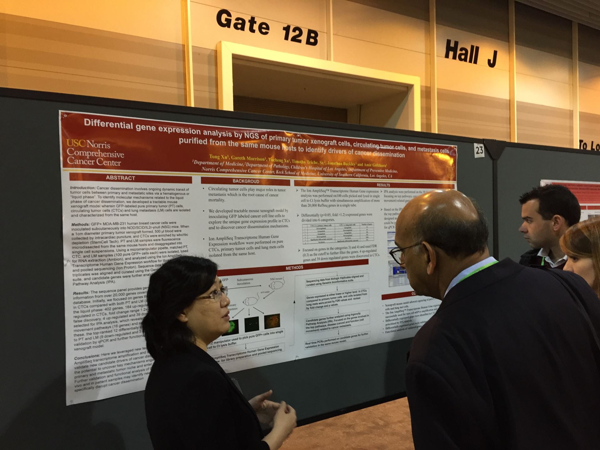 Tong presenting to someone at AACR 2016