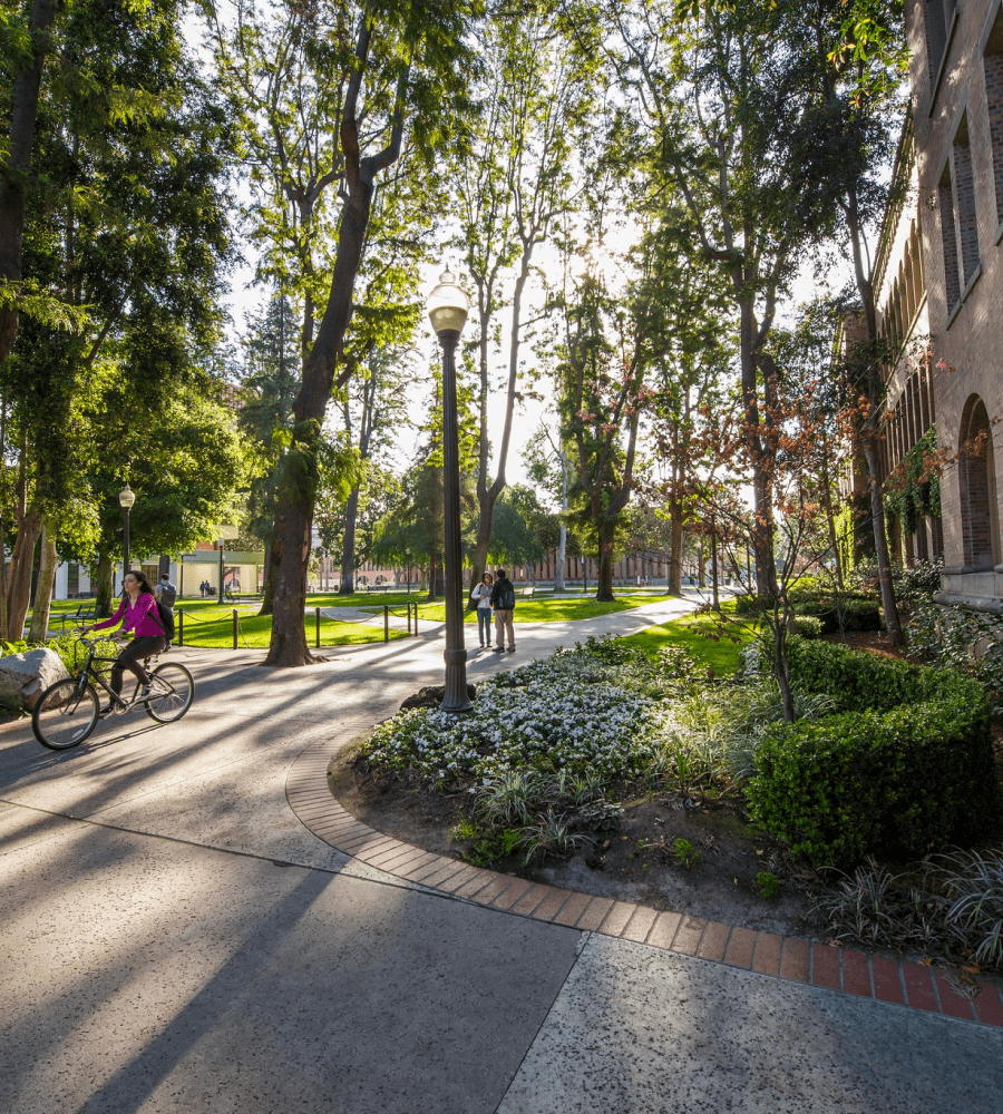 USC campus with students walking and biking.