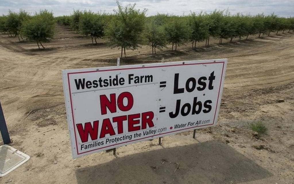 Photo of a sign reading "Westside farm No Water = Lost Jobs"