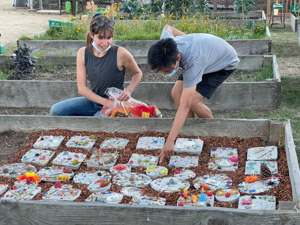 Leslie Dinkin and Jonathan Tolentino working on the memory garden during the Willowbrook Memory Procession, Nov. 2021.